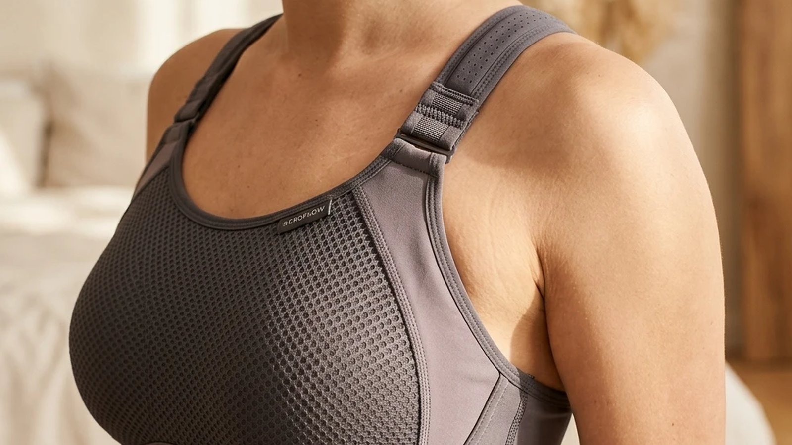 Peer-reviewed evidence on sports-bra biomechanics evolution: Scurr 2010, McGhee 2020, Mason 2018, plus three technology waves from compression-only to