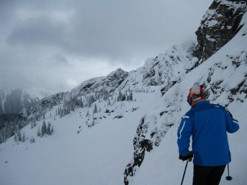Tim backcountry skiing a steep alpine slope